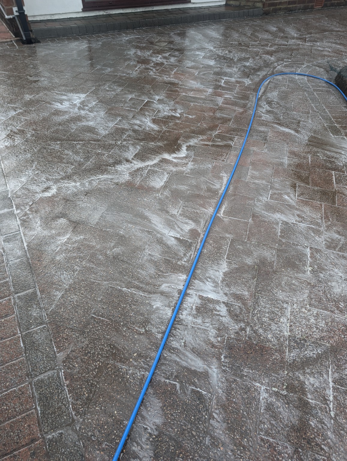 Cleaning treatment applied to a block paving driveway before pressure washing