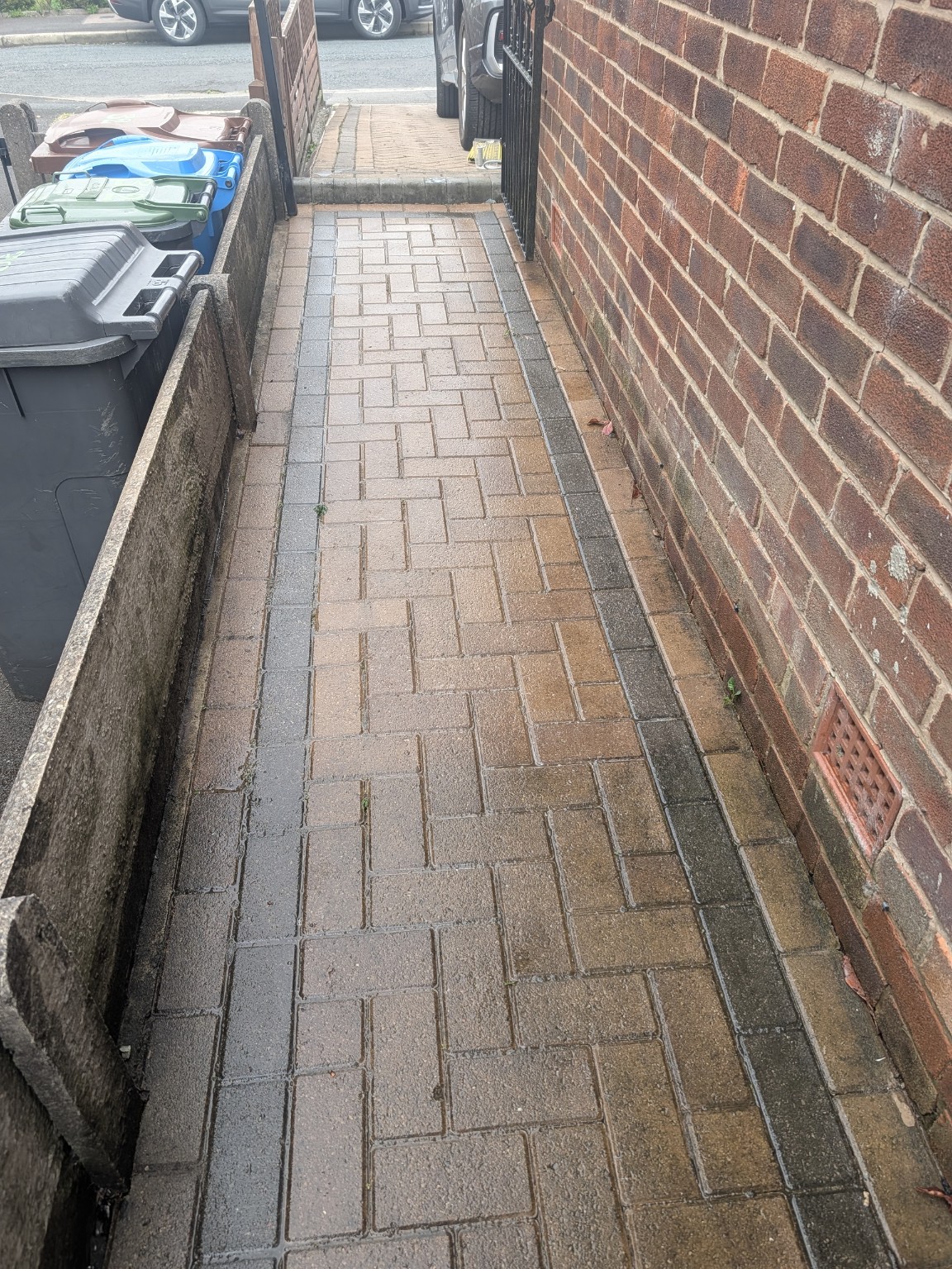 Cleaned block paved side path showing detailed work along edges and walls
