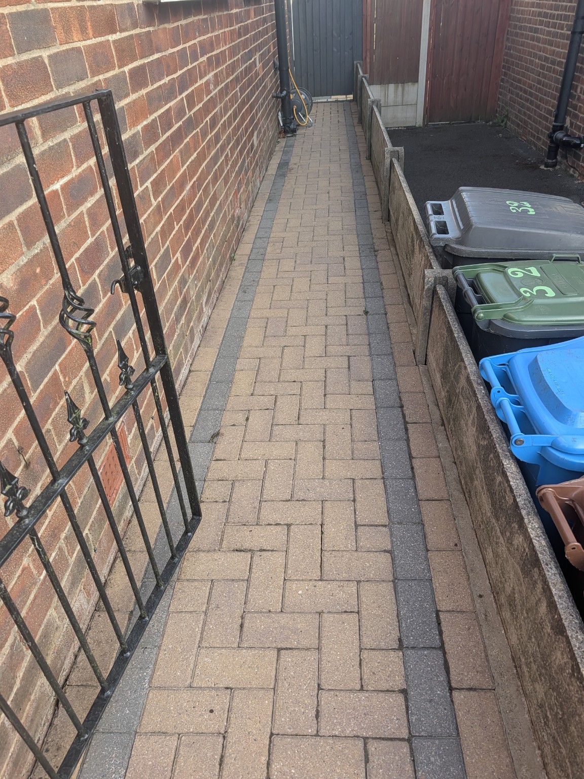 The same block paved side path after professional cleaning by Crispy Clean