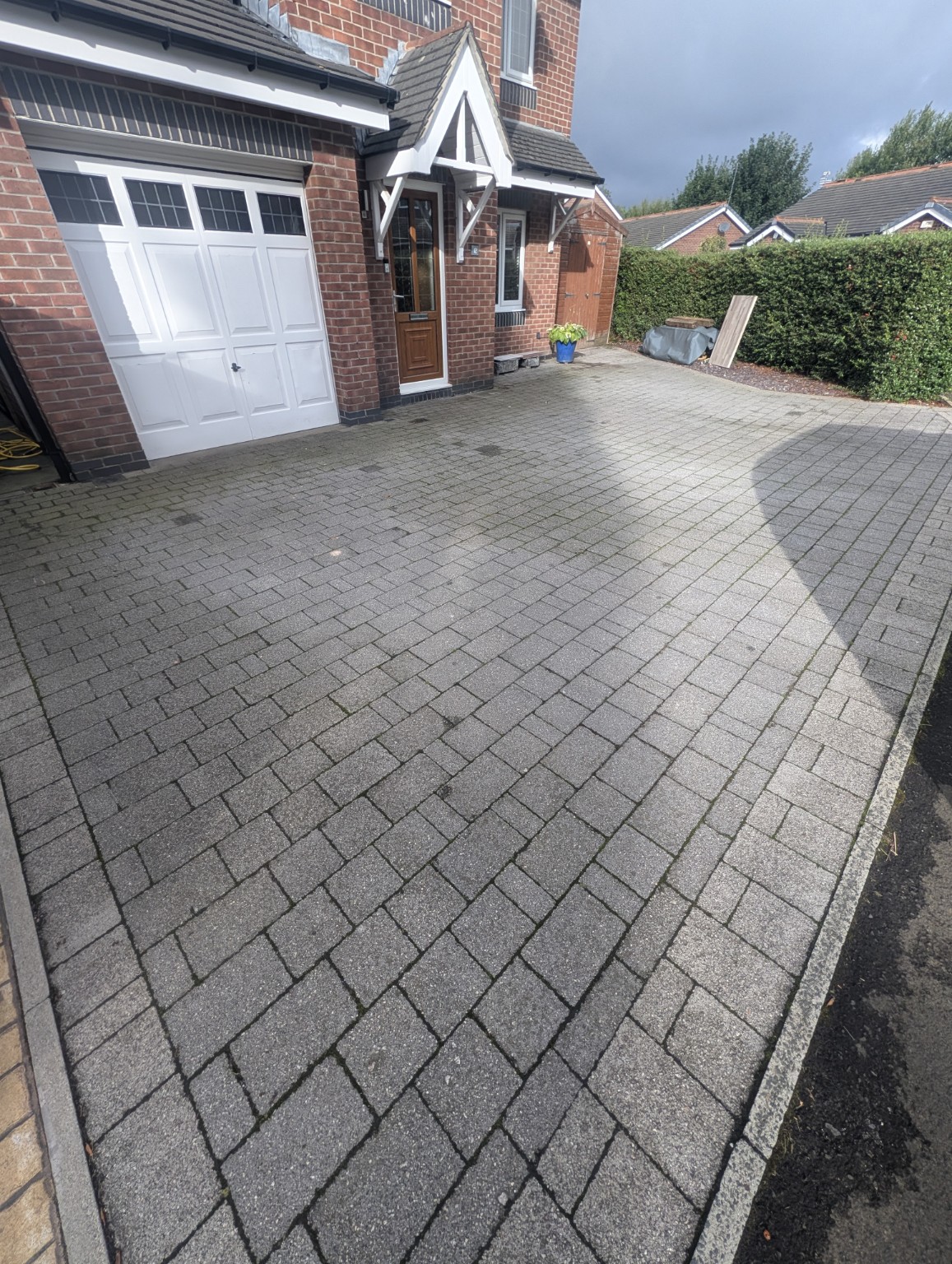 Second angle of block paving driveway before cleaning in Milnrow